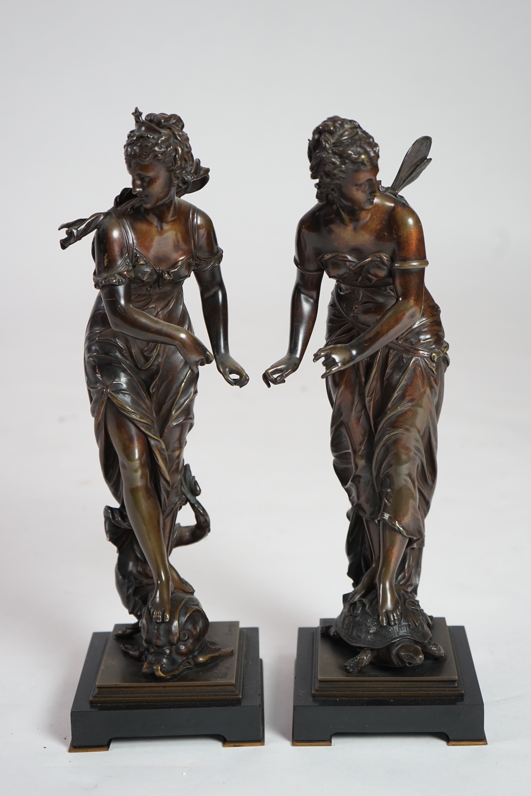 Eutrope Bouret, (French 1833-1906). A pair of late 19th century patinated bronze figures of Venus riding a dolphin and a nymph riding a tortoise